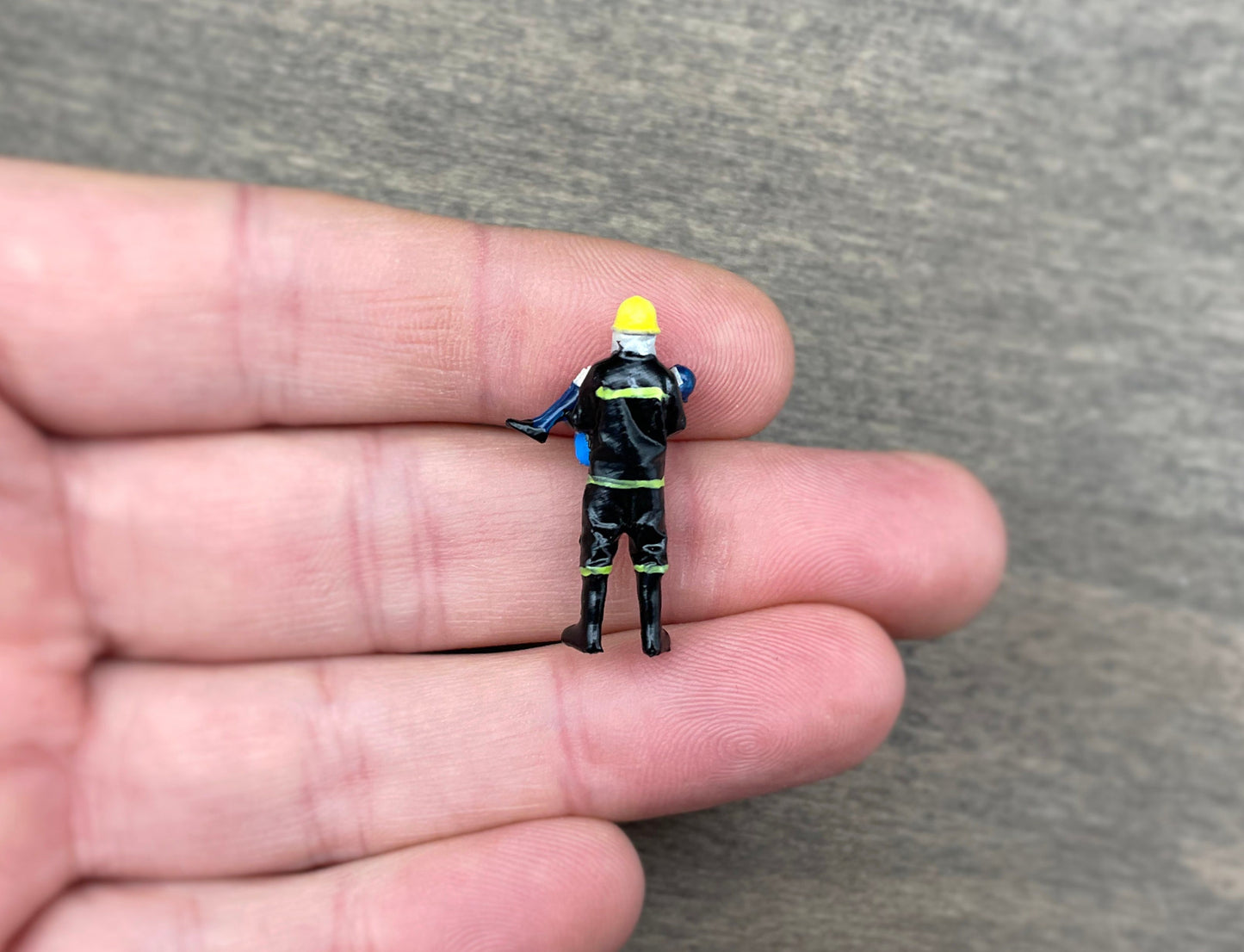 Fireman Saving Girl. Miniature Human Figure. 1:64 Scale